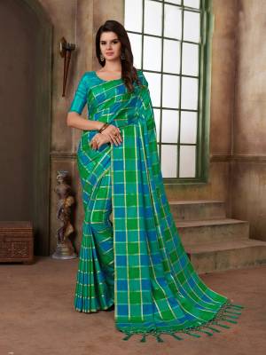Look Pretty In This Green And Blue Colored Saree Paired With Turquoise Blue Colored Blouse. This Saree And Blouse Are Silk Based Beautified With Checks Prints all Over It.