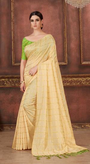 Simple And Elegant Looking Saree Is Here In Cream Color Paired With Contrasting Light Green colored Blouse. This Saree And Blouse Are Silk Based With Checks Prints And Embroidered Blouse. 