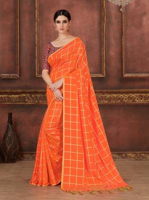 Celebrate This Festive Season Wearing This Designer Saree In Orange Color Paired With Contrasting Wine Colored Blouse. This Saree Is Silk Based Paired With Art Silk Fabricated Embroidered Blouse. Buy Now.