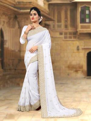 Simple And Elegant Looking Saree In White Color Paired With White Colored Blouse. This Saree and blouse Are Georgette Based Beautified with Heavy Embroidery. Buy Now.