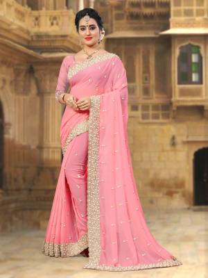 Attract All Wearing This Designer Saree In Pink Color Paired With Pink Colored Blouse. This Saree And Blouse Are Fabricated On Georgette Beautified With Heavy Embroidered Lace Border. Buy This Saree Now.