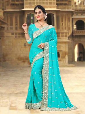 Lovely Shade In Blue Is Here With This Designer Saree In Turquoise Blue Color Paired With Turquoise Blue Colored Blouse. This Saree And Blouse Are Georgette Based Beautified With Heavy Embroidered Lace Border.