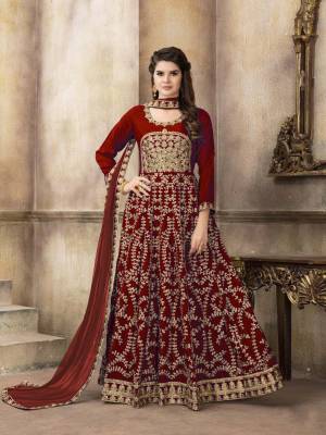 Add This Attractive Looking Heavy Designer Floor Length Suit To Your Wardrobe In Maroon Color Paired With Maroon Colored Blouse. Its Top Is Fabricated On Art Silk Paired With Santoon Bottom And Net Dupatta. It Is Beautified With Jari Embroidery And Stone Work. 