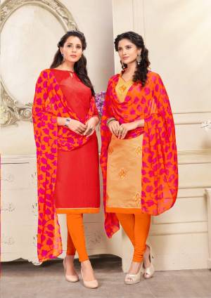 Here Is An elegant Looking Pair In Dress Material With Two Tops. Its Red Top Is Fabricated On Cotton And Beige Is Chanderi Based Paired With Orange Colored Cotton Bottom And Orange And Pink Chiffon Dupatta. Buy Now.