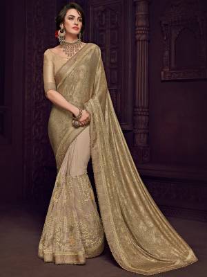 Look your ethnic best by wearing this gold and beige color Designer imported fabrics saree. Ideal for party, festive & social gatherings. this gorgeous saree featuring a beautiful mix of designs. Its attractive color and designer imported heavy embroidered design, flower design and moti design, stone design, beautiful floral design work over the attire & contrast hemline adds to the look. Comes along with a contrast unstitched blouse.