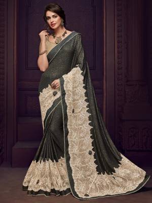 Look gorgeous in this beautiful printed Dark Grey and beige color Designer imported fabrics saree. Ideal for party, festive & social gatherings. this gorgeous saree featuring a beautiful mix of designs. Its attractive color and designer imported heavy embroidered design, flower patch design and moti design, stone design, beautiful floral design work over the attire & contrast hemline adds to the look. Comes along with a contrast unstitched blouse.