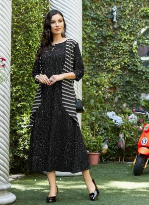 Simple Kurti IS Here For Your Casual Or Semi-Casual Wear In Black Color Which Is Rayon Based. It Is Beautified With Unique Prints. Buy Now.