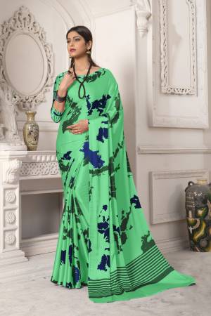 Look Pretty In This Sea Green  Colored Saree Paired With Sea Green Colored Blouse, This Saree And Blouse Are Fabricated On Satin Silk Beautified With Abstract Prints All Over It. It Is Light Weight And Easy To Carry All Day Long. Buy Now.