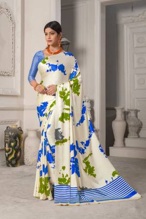 Simple And Elegant Looking Saree Is Here In White Color Paired With Blue Colored Blouse. This Saree And Blouse Are Fabricated On Satin Silk Beautified With Multi Colored Prints Giving It An Attractive Look.