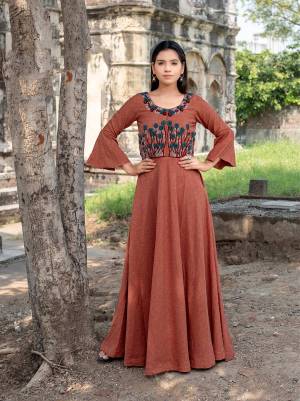 Add This New Shade To Your Wardrobe With This Designer Readymade Long Kurti In Rust Color Fabricated On Cotton. It Has Beautiful Bell Sleeve Pattern With Contrasting Thread Work Over The Yoke. 