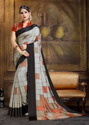 Flaunt Your Rich And Elegant Taste Wearing This Saree In Grey Color Paired With Contrasting Rust Orange Colored Blouse. This Saree And Blouse Are Art Silk Based Beautified With Bold Checks All Over It.