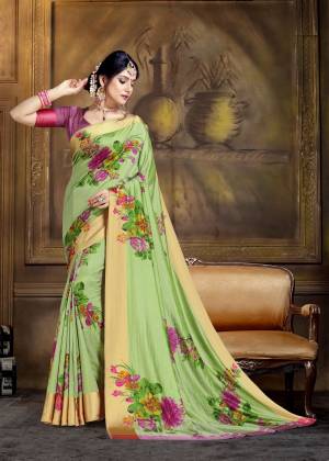 For A Proper Traditional Look, Grab This Pretty Saree In Light Green Color Paired With Contrasting Magenta Pink Colored Blouse. This Saree And Blouse Are Fabricated On Art Silk Beautified With Bold Floral Prints All Over. 