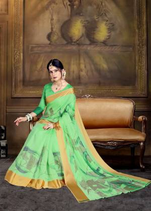 For A Proper Traditional Look, Grab This Pretty Saree In Light Green Color Paired With Light Green Colored Blouse. This Saree And Blouse Are Fabricated On Art Silk Beautified With Bold Floral Prints All Over. 
