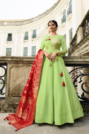Proper Traditional Combination Is Here With This Designer Floor Length Readymade Gown In Light Green Colored Top Paired With Contrasting Red Colored Dupatta. Its Top Is Silk Based Paired With Banarasi Silk Dupatta. Buy This Now.