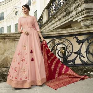 Look The Most Prettiest Of All Wearing This Designer Floor Length Gown In Baby Pink Paired With Contrasting Red Colored Dupatta. Its Top Is Silk Based Paired With Banarasi Silk Dupatta. Buy Now.