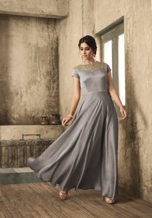 Flaunt Yourt Rich And Elegant Taste On You And Even On Your Daughter With This Elegant Looking Designer Floor Length Gown In Grey Color Fabricated On Satin. It Has Embroidered Yoke Giving It An Attractive Look. 