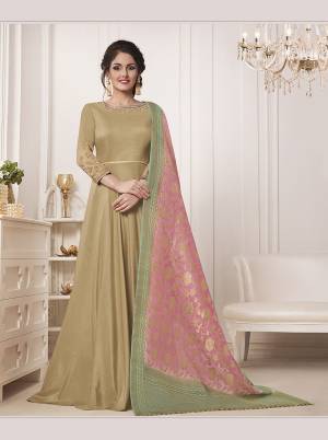 Flaunt Your Rich And Elegant Taste Wearing This Designer Floor Length Suit In Beige Color Paired With Pretty Baby Pink Colored Dupatta. Its Top IS Muslin Silk Based Paired With Santoon Bottom And Banarasi Silk Dupatta. Its Rich Color Will Earn You Lots Of Compliments From Onlookers.