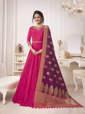 Shine Bright In This Attractive Looking Designer Floor Length Suit In Rani Pink Color Paired With Contrasting Wine Colored Dupatta. Its top Is Fabricated On Muslin Silk Paired With Santoon Bottom And Banarasi Silk Dupatta. Buy This Now.