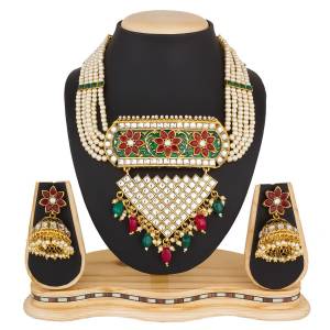 Short And Pretty Necklace Set Is Here In Golden Color Beautified With Maroon And Green Colored Stone And Kundan Work. Buy Now.