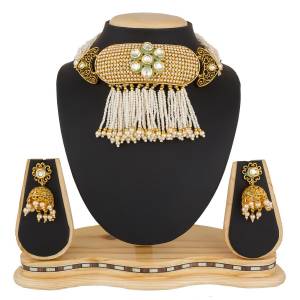 Another Heavy Choker Necklace Set IS Here In Golden Color Beautified With White Colored Stone And Moti Work. This Can Be Paired With Any Colored Traditional Attire.