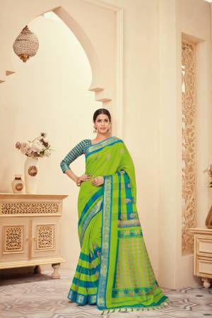 Attractive looking Saree Is Here In Green Color Paired With Contrasting Blue Colored Blouse. This Saree And Blouse Are Silk Based Beautified With Prints Over IT .