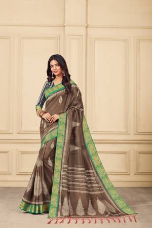 New Shade Is Here To Add Into Your Wardrobe With This Silk Based Saree In Sand Brown Color Paired With Contrasting Navy Blue  colored Blouse. It Has Pretty Simple Prints Over The Saree. Buy Now.