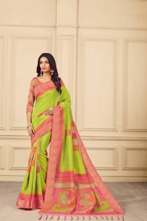 Attractive looking Saree Is Here In Parrot Green Color Paired With Contrasting Pink Colored Blouse. This Saree And Blouse Are Silk Based Beautified With Prints Over IT .