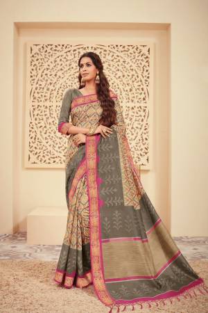 Flaunt Your Rich And Elegant Taste Wearing This Saree In Cream And Grey Color Paired With Grey Colored Blouse. This Saree And Blouse Are Silk Based Beautified With Prints. 