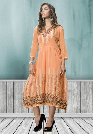 This kurti looks appealing owing to the beautiful pattern and its vibrant color combination. This kurti has white and beige colored leaf embroidery work on the neck line and lower part. The orange colored kurti is fabricated in georgette, while the inner is made of santoon fabric. Buy this pretty kurti now.