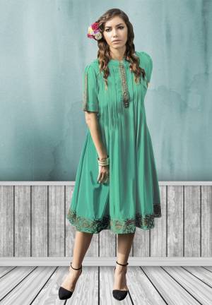 This kurti is designed as per the latest trends to keep you in sync with high fashion. This amazing kurti has brown colored floral embroidery work on the neck line and border. The Sea green colored kurti is fabricated in georgette, while the inner is made of santoon fabric. This charming kurti just for you.