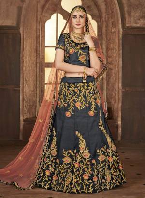 Flaunt Your Rich And Elegant Taste Wearing This Heavy Designer Lehenga Choli In Dark Grey Color Paired With Contrasting Peach Colored Dupatta. Its Blouse And Lehenga Are Satin Silk Based Paired With Net Dupatta. Its Fabric Are Ensures Superb Comfort Throughout The Gala.