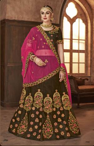 For A Royal Look, Grab This Heavy Designer Lehenga Choli In Brown Color Paired With Contrasting Pink Colored Dupatta. Its Blouse And Lehenga Are Fabricated On Satin Silk Paired With Net Fabricated Dupatta. 