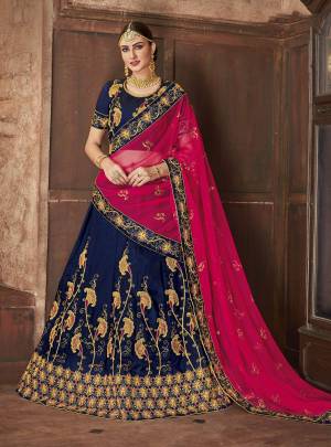 Add This Beautiful Heavy Designer Lehenga Choli In Blue Color Paired With Contrasting Pink Colored Dupatta. Its IS Satin Silk Based Paired With Net Fabricated Dupatta. Buy This Now.