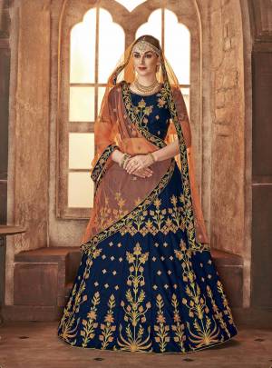 Add This Beautiful Heavy Designer Lehenga Choli In Blue Color Paired With Contrasting Light Orange Colored Dupatta. Its IS Satin Silk Based Paired With Net Fabricated Dupatta. Buy This Now.