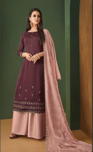 Look Pretty In This Beautiful Designer Suit In Wine Colored Top Paired With Contrasting Dusty Pink Colored Plazzo And Dupatta. Its Top Is Satin Georgette Fabricated Paired With Georgette Plazzo And Heavy Embroidered Georgette Dupatta. Buy Now.