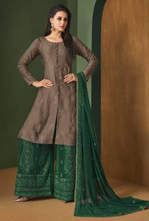 New Color Pallete Is Here With This Designer Straight Suit In Brown Colored Top Paired With Contrasting Dark Green Colored Bottom And Dupatta. Its Top Is Fabricated On Satin Georgette Paired With Georgette Bottom And Dupatta. It Has Tone To Tone Embroidery All Over It Which Gives A Subtle Look. 