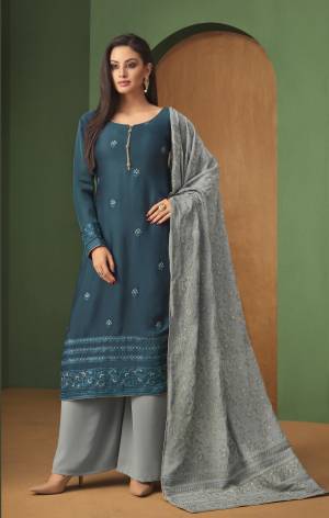 Celebrate This Festive Season With Beauty And Comfort Wearing This Designer Straight Plazzo Suit In Blue Colored Top Paired With Contrasting Grey Colored Bottom And Dupatta. Its Top Is Satin Georgette Based Paired With Georgette Bottom And Dupatta. 