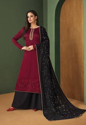 Rich And Elegant Looking Designer Suit Is Here In Maroon Colored Top Paired With black Colored Bottom And Dupatta. Its Top IS Fabricated On Satin Georgette Paired With Georgette Bottom And Dupatta. 