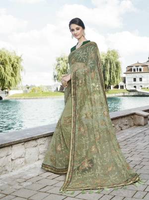 This Season Is About Subtle Shades And Pastel Play, So Grab This Heavy Designer Saree In Pastel Green Color Paired With Pine Green Colored Blouse. This Saree Is Fabricated Net Beautified With Attractive Embroidery All Over It.