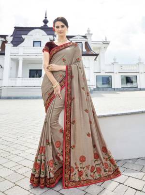 You Will Earn Lots Of Compliments Wearing This New Shade In Grey With This Designer Saree In Sand Grey Color Paired With Maroon Colored Blouse. This Saree And Blouse Are Silk Beautified With Contrasting Embroidery. 