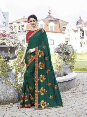 Add This Beautiful Designer Saree To Your Wardrobe In Teal Green Color Paired With Contrasting Red Colored Blouse. This Saree And Blouse Are Silk Based Beautified With Contrasting Thread And Jari Work.