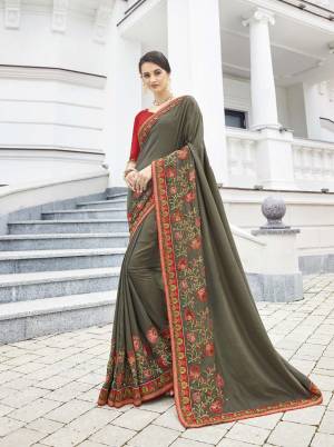 Flaunt Your Rich And Elegant Taste Wearing This Designer Saree In Grey Color Paired With Contrasting Red Colored Blouse. This Saree And Blouse Are Silk based Which Gives A Rich Look To Your Personality.