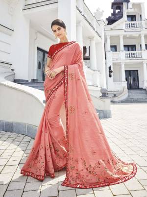 Look Pretty Wearing This Light Pink Colored Saree Paired With Contrasting Red Colored Blouse. This Saree And Blouse Are Silk Based Beautified With Elegant Embroidery. 