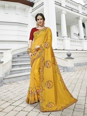 Celebrate This Festive Season with Colorful Attire Wearing This Designer Saree In Yellow Color Paired With Contrasting Red Colored Blouse. This Saeee Is Fabricated On Soft Silk Paired With Art Silk Fabricated Blouse. 