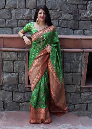 Have A Fresh And Pretty Look Everytime You Wear This Saree In Green Color Paired With Green Colored Blouse. This Saree And Blouse are Silk based Beautified With weave All Over. 