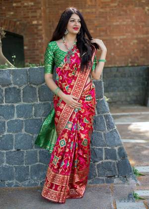 Adaorn A Proper Traditional Look Wearing This Beautiful Saree In Red Color Paired With Contrasting Green Colored Blouse. This Saree And Blouse Are Fabricated On Art Silk Beautified With Weave All Over It. 