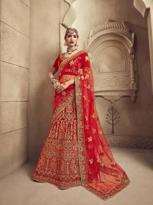 Get Ready For The D-Day With This Beautiful Heavy Designer Lehenga Choli In Red Color Paired With Red Colored Dupatta. Its Blouse And Lehenga Are Velvet Fabricated Paired With Net Fabricated Dupatta. It Has Heavy Embroidery All Over It Giving It A Lovely Glam Look.