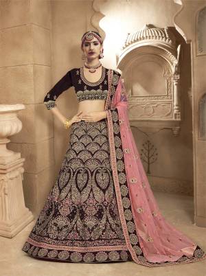 You Will Definitely Earn Lots Of Compliments With This Lovely Color Pallete Designer Lehenga Choli In Dark Wine Color Paired With Contrasting Pink Colored Dupatta. Its Blouse And Lehenga Are Velvet Based Paired With Net Fabricated Dupatta. Buy Now.