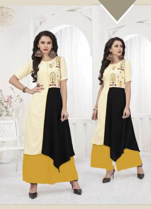 Simple and Elegant Looking Pretty Readymade Kurti Is Here In Cream And Black Color Fabricated On Rayon Beautified With Thread Work. Buy Now.