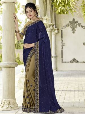 Gorgeously mesmerizing is what you will look at the next wedding gala wearing this beautiful Navy Blue and beige color two tone bright georgette saree. Ideal for party, festive & social gatherings. this gorgeous saree featuring a beautiful mix of designs. designer embroidered saree, patch design, heavy designer blouse, two color sarees, beautiful floral design Comes along with a contrast unstitched blouse.